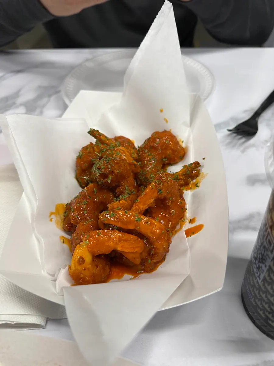 Customer photo: buffalo shrimp tossed in sauce in a paper boat at Wing Kings Eastlake