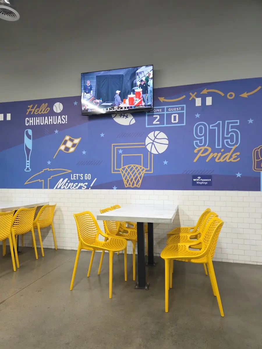 Customer photo: the Wing Kings Eastlake dining room with its 915 Pride sports mural and yellow chairs