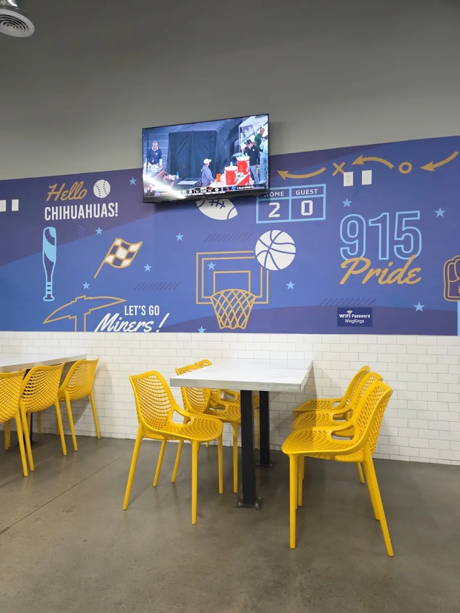 Customer photo: the Wing Kings Eastlake dining room with its 915 Pride sports mural and yellow chairs